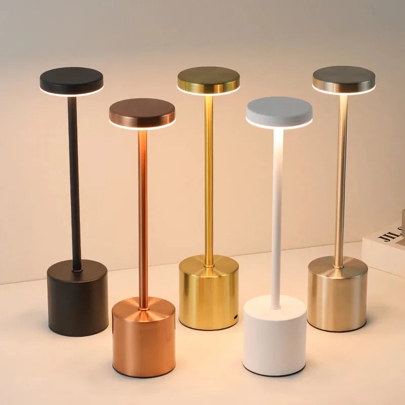 Cordless touch LED table lamp glowing warmly on a bedside table